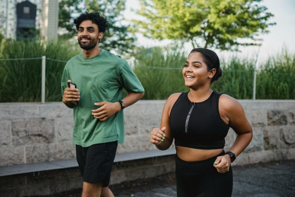 Exercise plays an equally vital role in regulating hormones and boosting libido Lins Hearts Man and Woman Smiling While Jogging Together